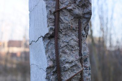 part of a gray concrete broken pillar with rusty brown reinforce